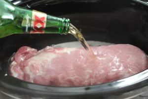 Pork with beer being poured on it