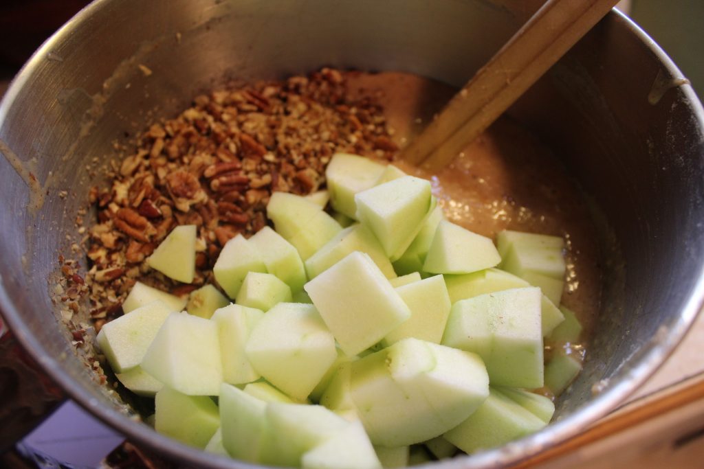 adding apples and pecans to batter