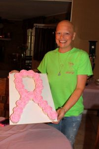 Margo holding a pink ribbon cake