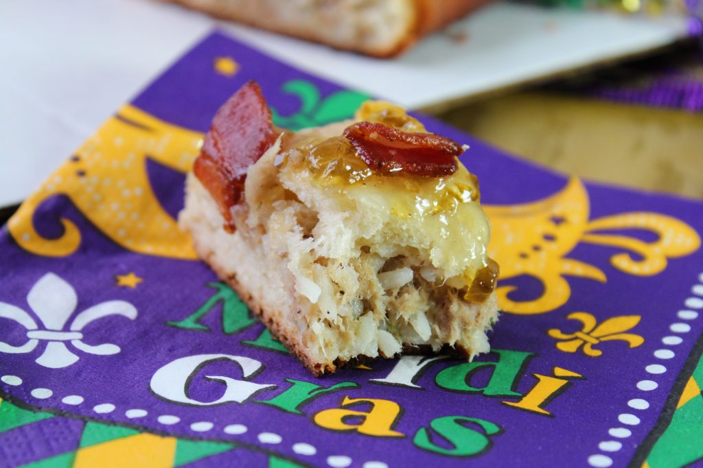 a slice of boudin stuffed king cake with a bite taken