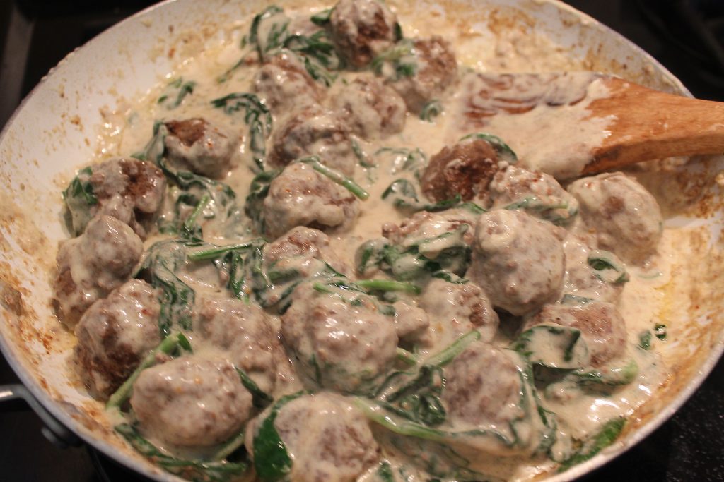 meatballs mixed with creamy spinach