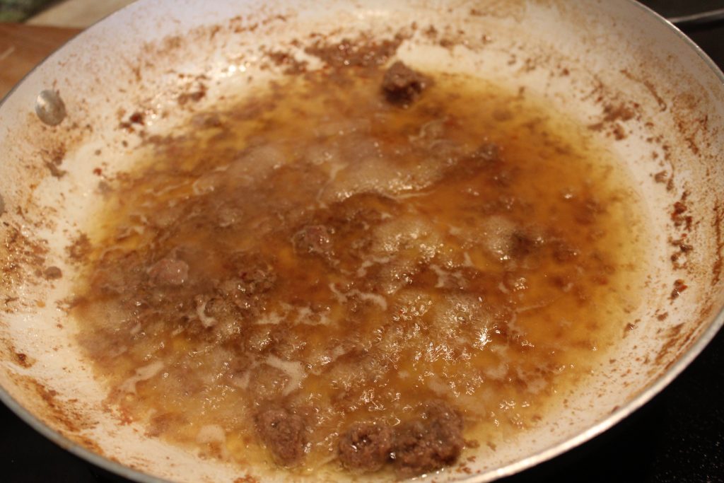 reducing broth in pan