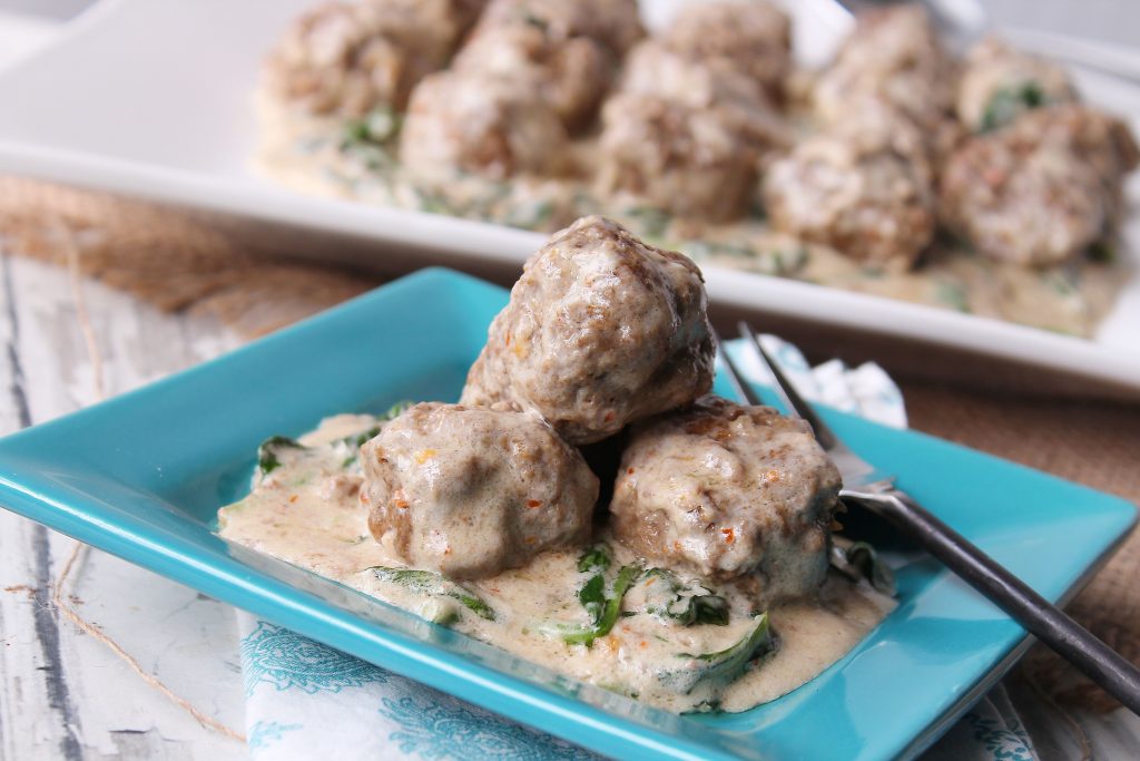 Low Carb Meatballs and Creamy Spinach on a small blue plate