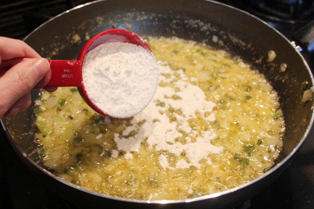 adding flour to butter and veggies