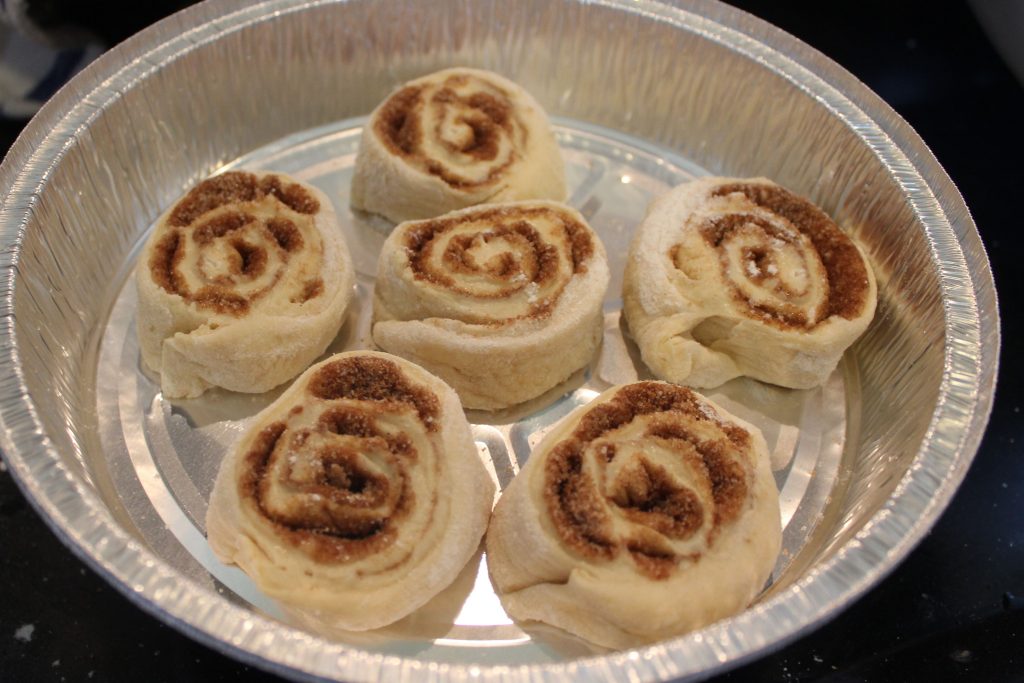 cinnamon rolls in aluminum pan before rising