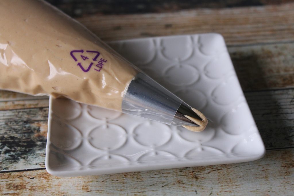 Creamy Peanut Butter Frosting on a piping bag