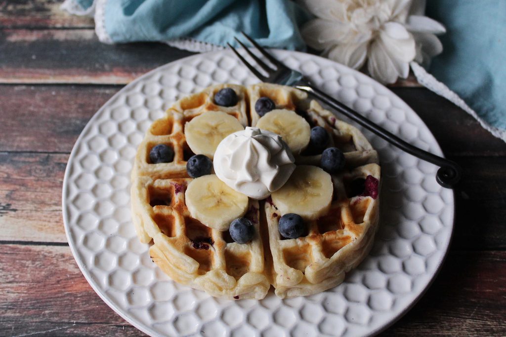 a Banana Blueberry waffle on a white plate