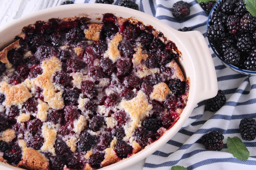 Blackberry cobbler in white baking dish