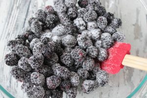 Tossing blackberries with sugar