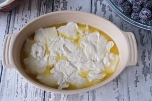 Baking dish with cobbler batter abd butter
