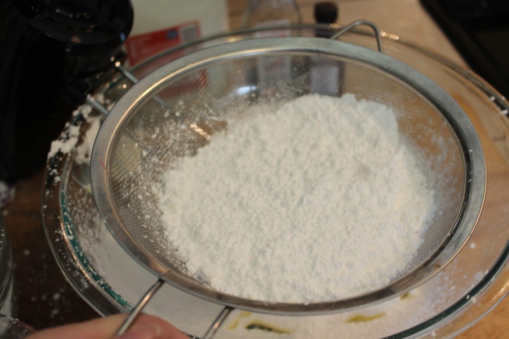 sifting powdered sugar for frosting