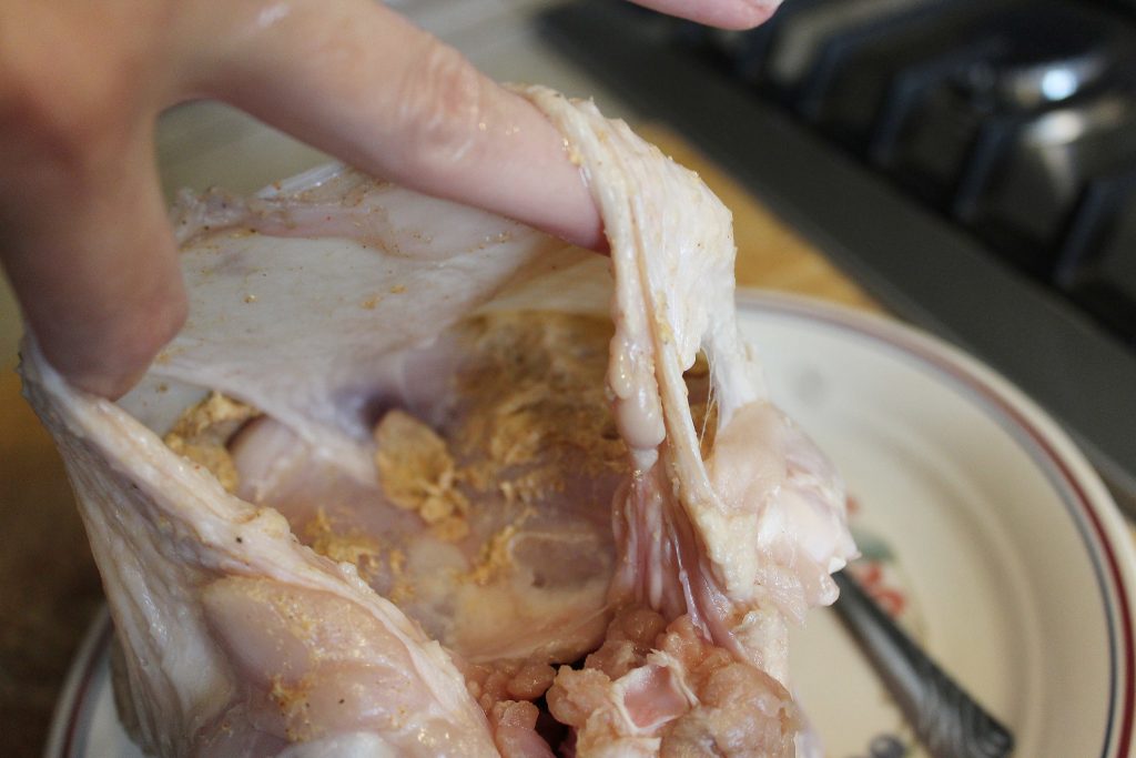 Seasoning the raw turkey breast