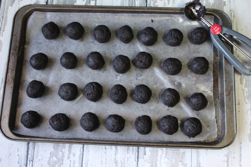 rolled cake balls on wax paper lined cookie sheet
