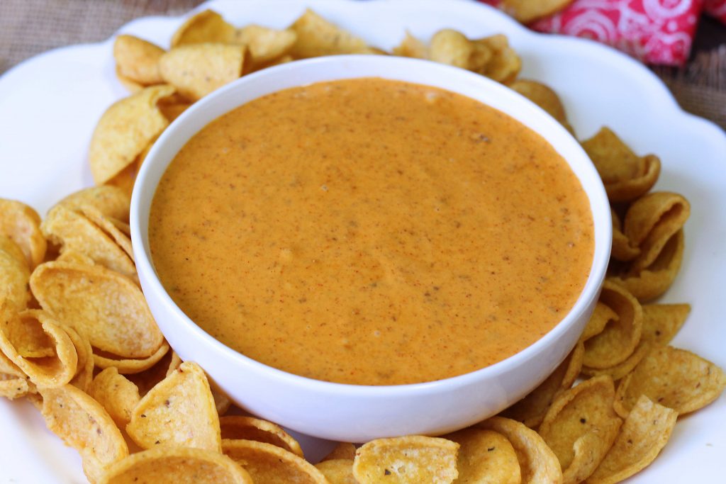A white bowl of chili cheese dip