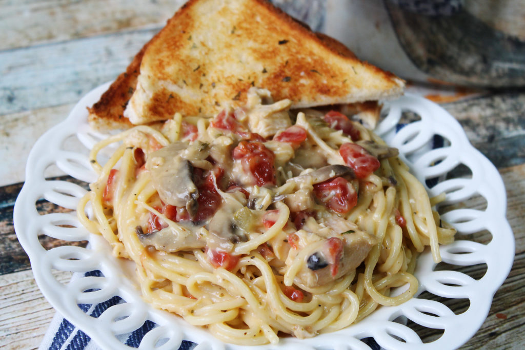 Pantry Chicken Spaghetti on a plate with garlic toast.