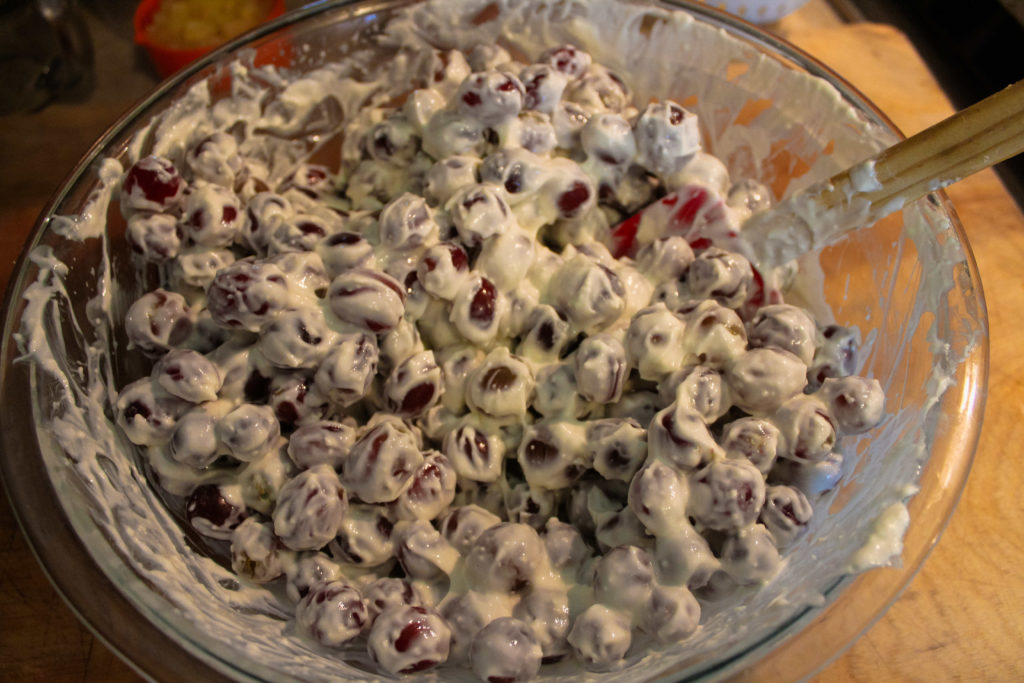Folding grapes into the cream cheese mixture