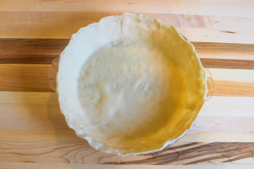 Preparing bottom crust for fresh peach pie