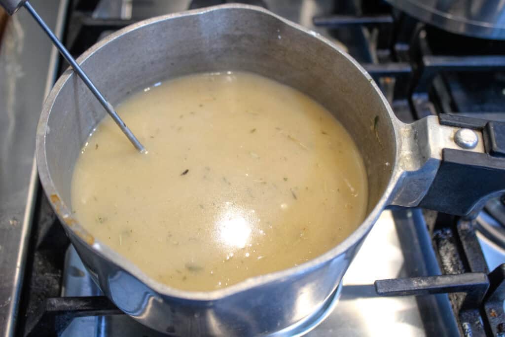 old fashioned turkey Gravy cooking in a saucepam