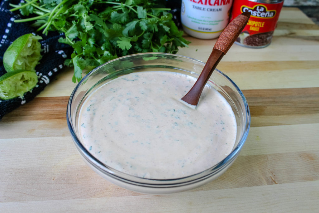 Chipotle Crema in a serving bowl with a spoon