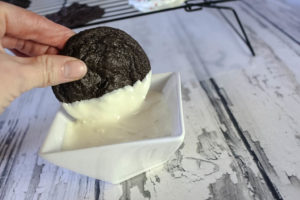 Dipping chocolate cookie in white chocolate