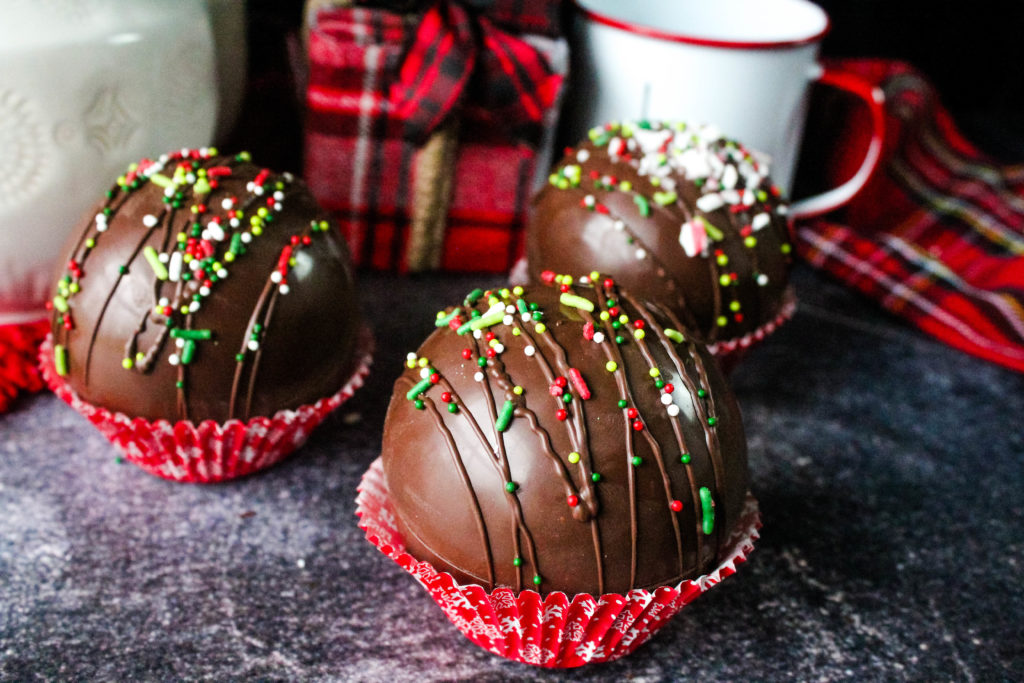 3 Hot Cocoa Bombs in a cupcake liner decorated for Christmas