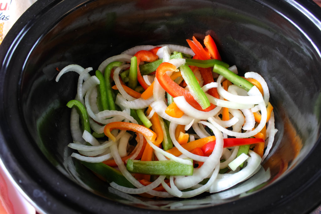 Onions and bell pepper in a slow cooker