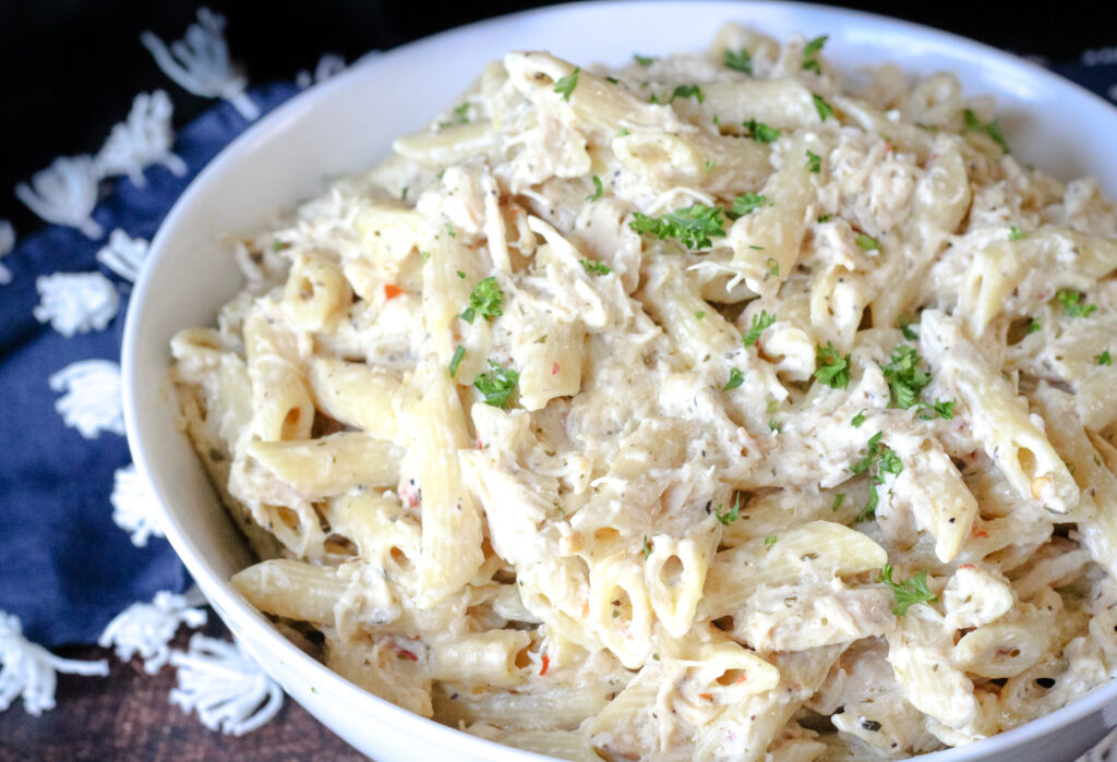Creamy slow cooker chicken with pasta in a serving bowl
