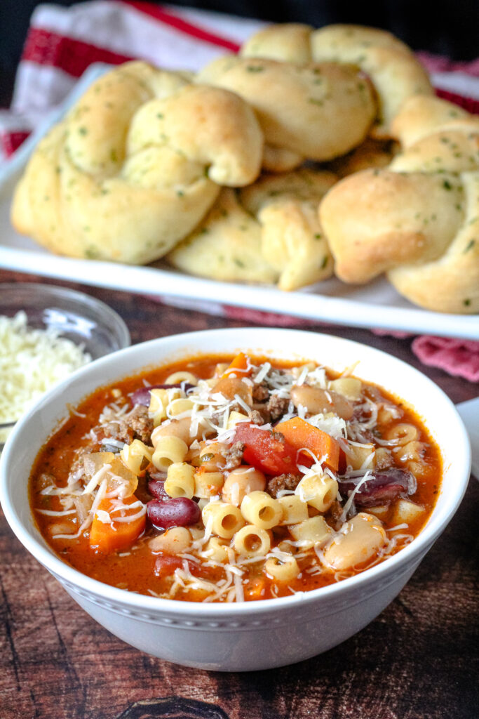 Easy Pasta e Fagioli in a white bowl with grated cheese on top. 