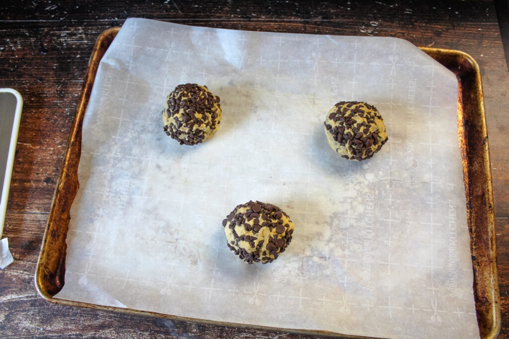 Cookie dough balls on cookie sheet ready to be baked 