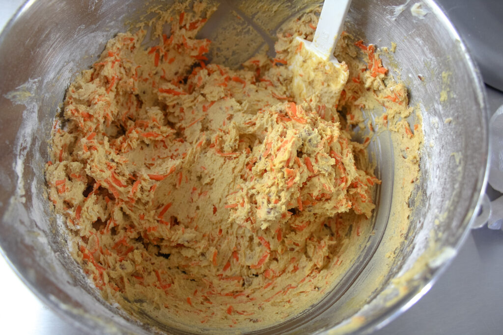 Crumbl Carrot Cake Cookies dough all mixed in a mixing bowl