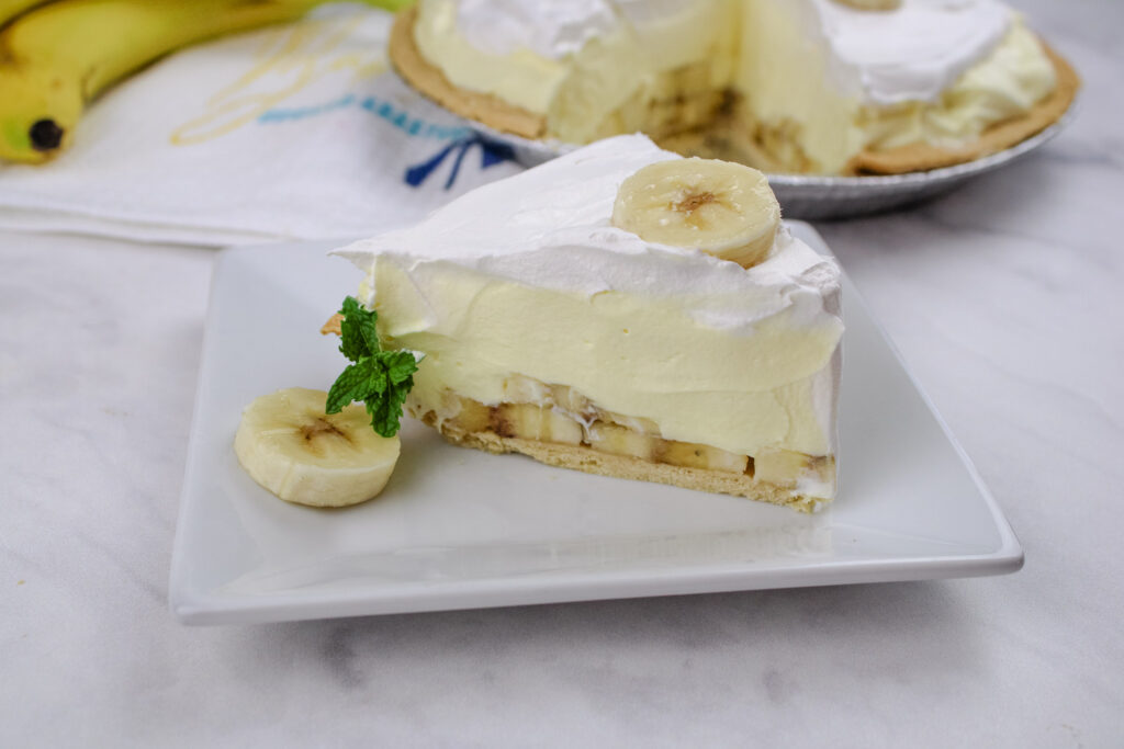 A slice of Easy Banana cream pie on a white plate 