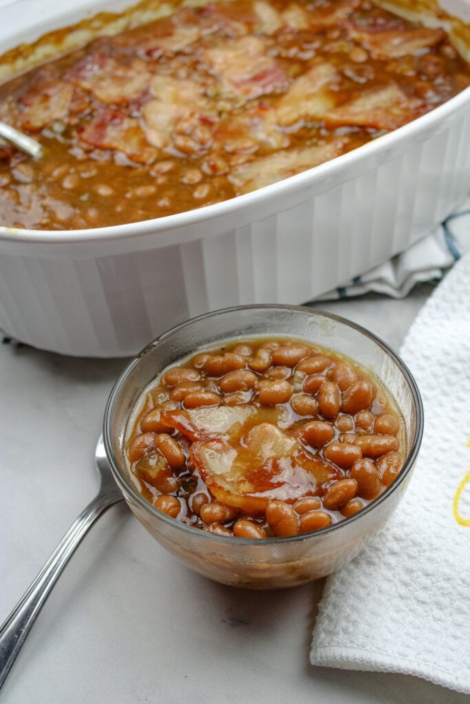 Southern Baked Beans in a small bowl next to a caking dish