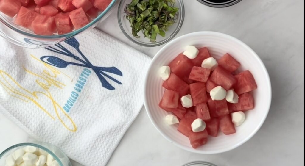 Mozzarella and cubed watermelon in a white bowl 