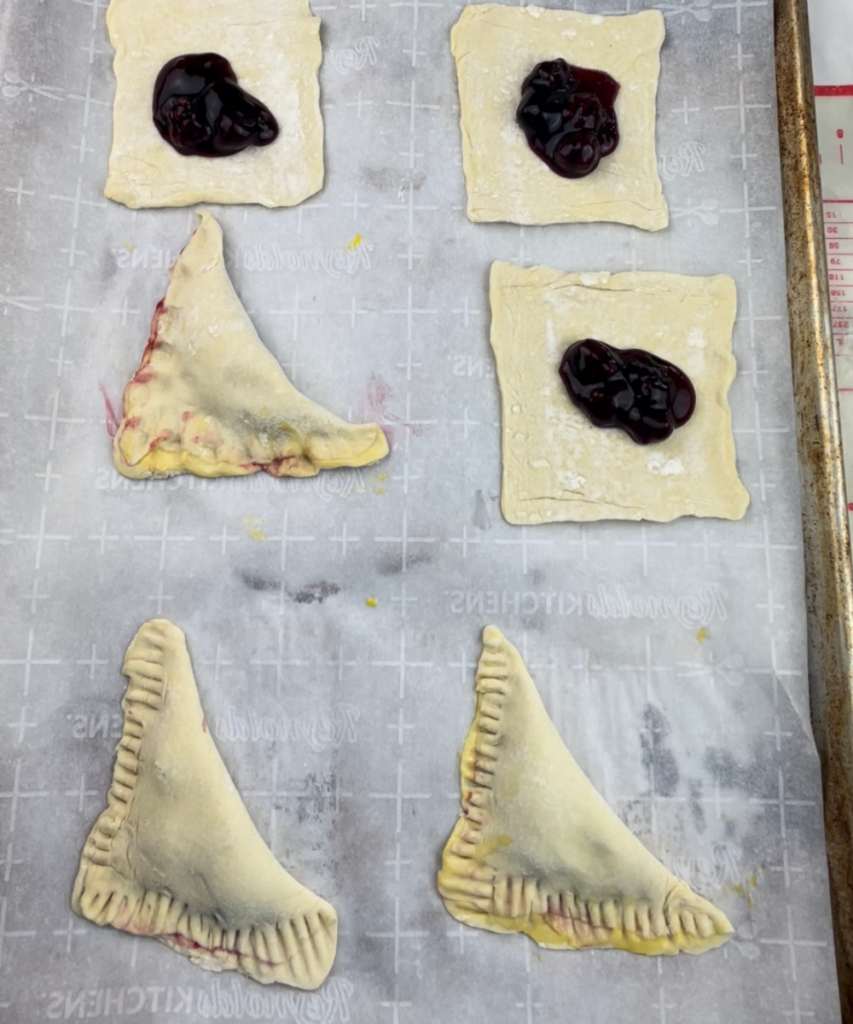 The edges of blackberry turnovers pinched and crimped