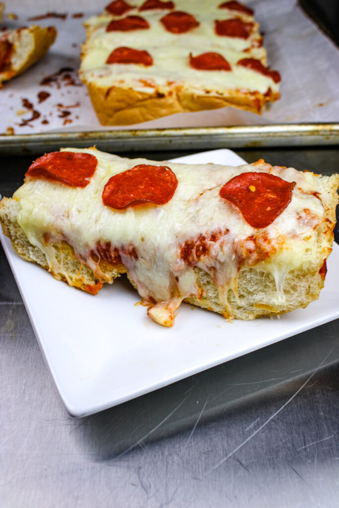 A slice of french bread pizza on a small plate 