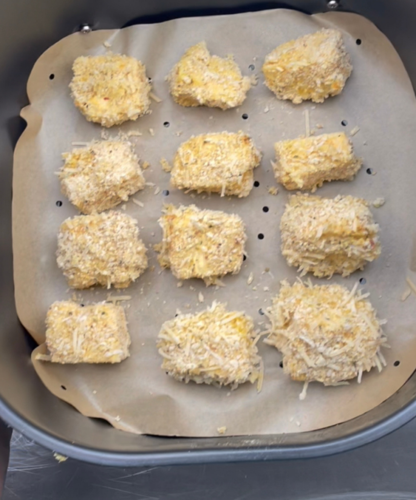 Air Fryer Mac and Cheese Bites in an air fryer basket 
