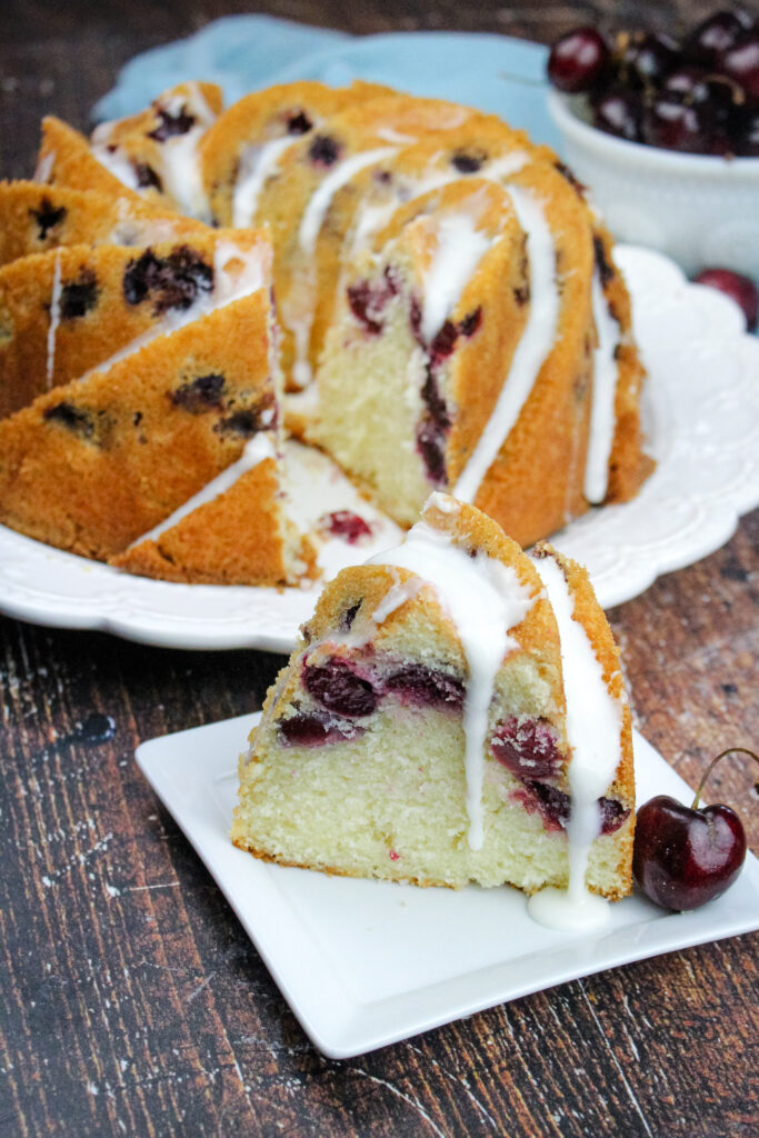 A slice of Cherry amaretto bundt cake on a small white plate 