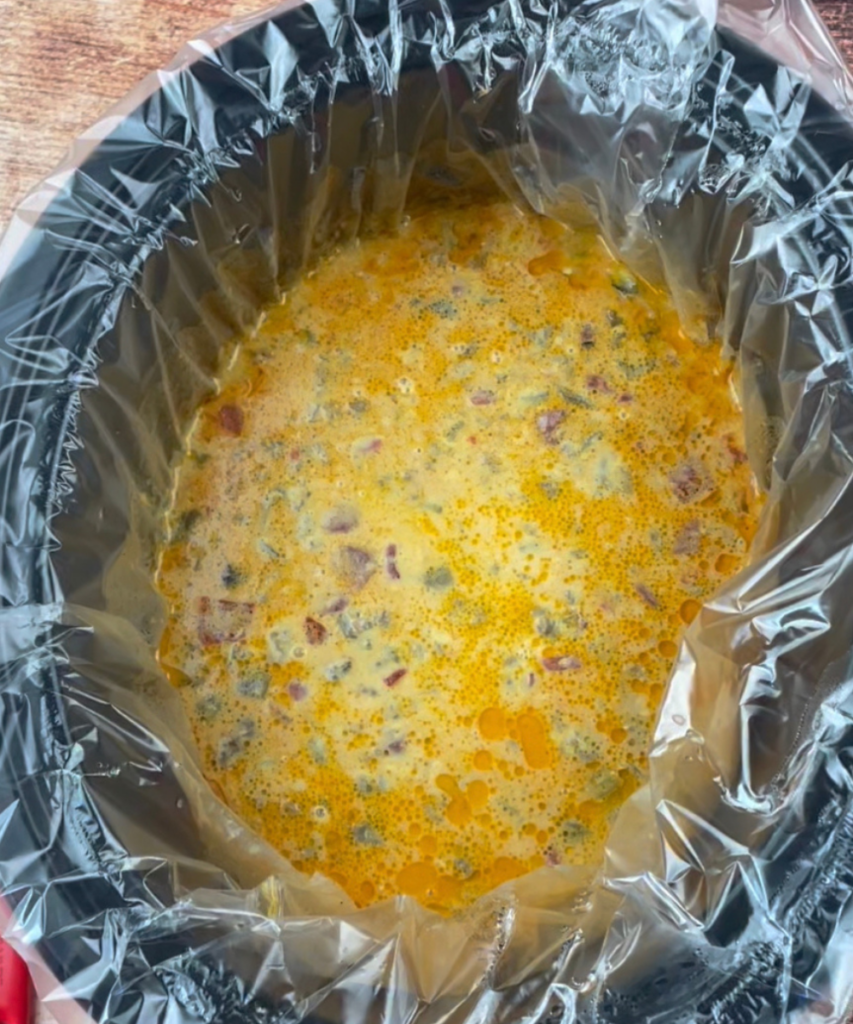 Taco cheese dip in a slow cooker with a liner 