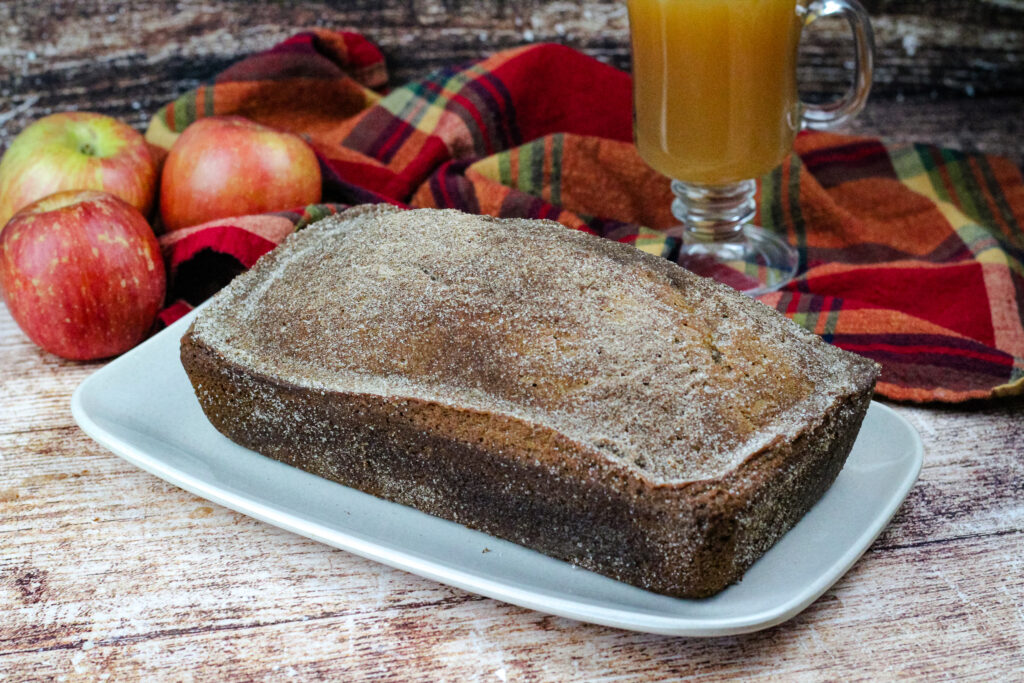 Apple cider bread on a platter before it is sliced 