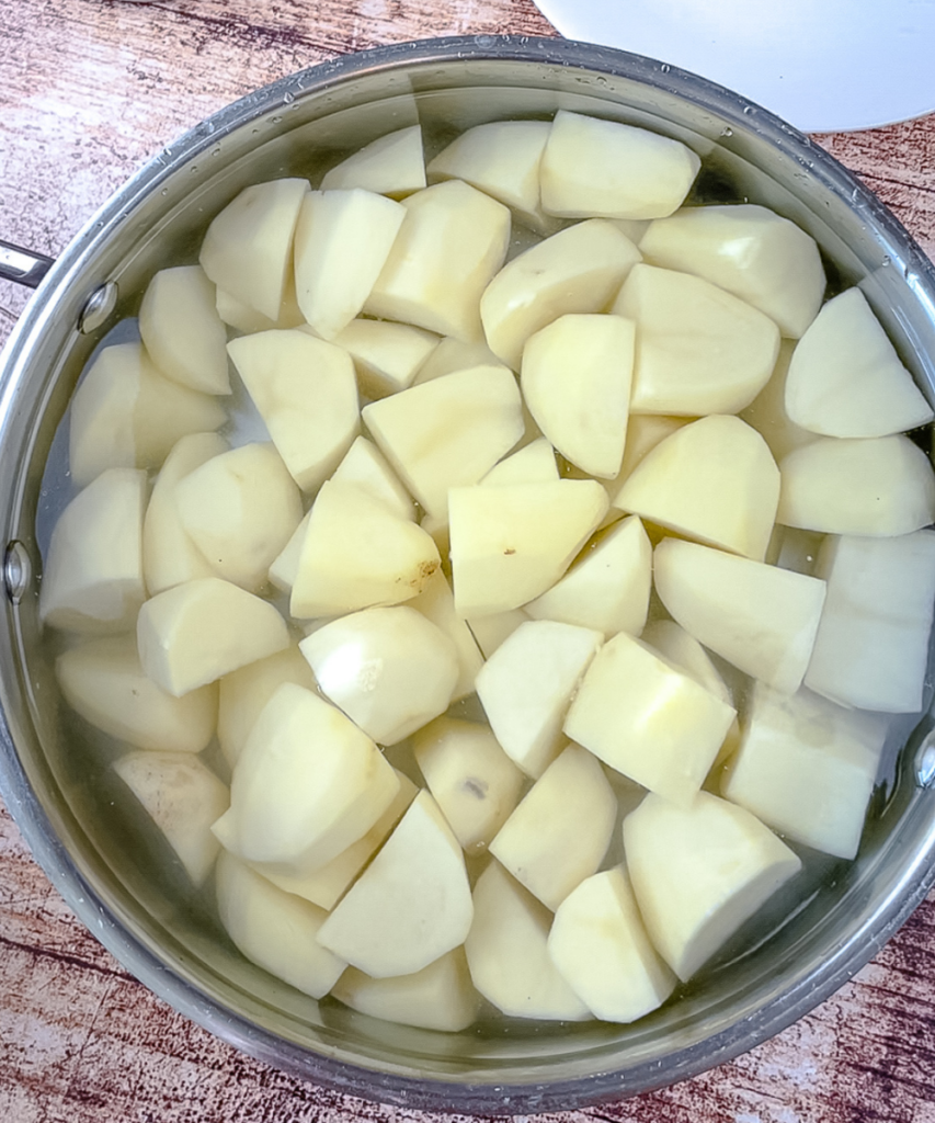Cut up potatoes in a pot with water