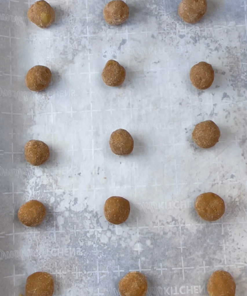 Cookie dough balls on a cookie sheet 