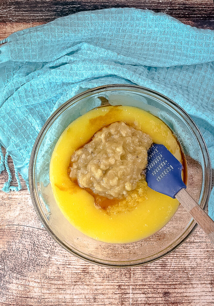 Adding the pineapple , banana , and vanilla to sugar mixture 