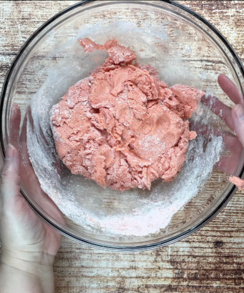 The strawberry cookie dough made in a mixing bowl