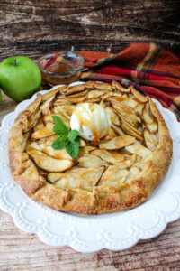 Caramel Apple Galette on a white platter with ice cream on top