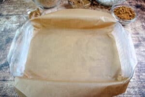 9x13 glass pan buttered and lined with parchment paper prepared for cookie butter rice krispie treats