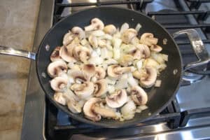 Mushrooms , onion and garlic cooking in a medium skillet for leftover steak quesadillas