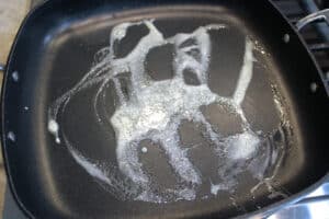 Heating a skillet with butter for leftover steak quesadillas