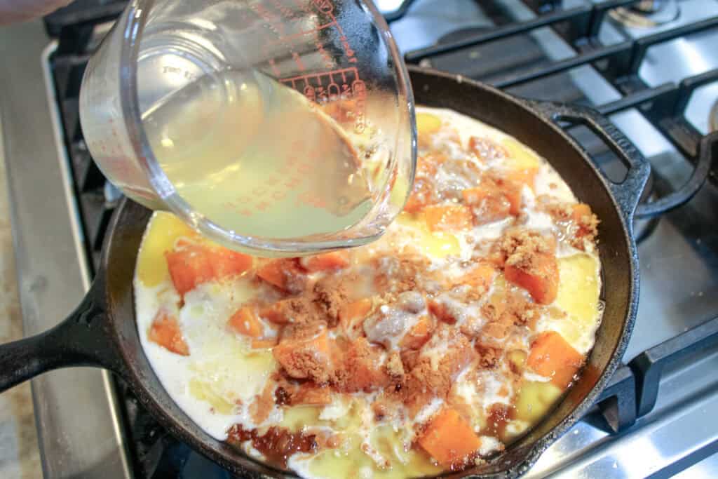 Pouring the boiling water over the mixture for easy sweet potato cobbler 