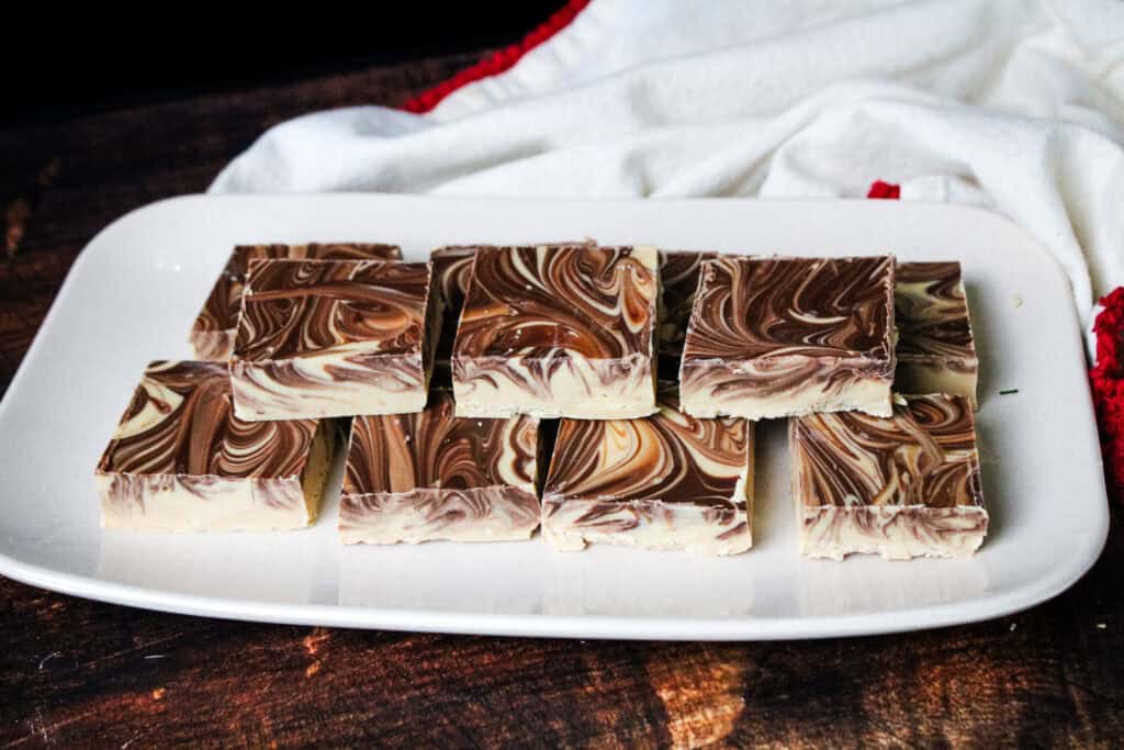 Tiger butter cut into squares stacked on a serving platter 