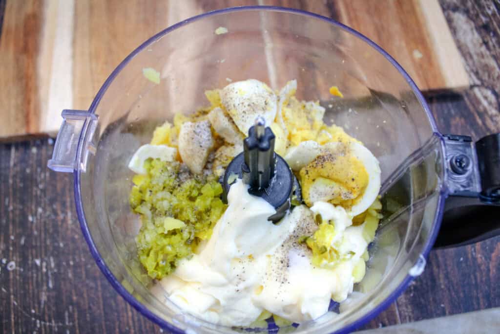 The filling for deviled potatoes in a food processor before it is blended . 